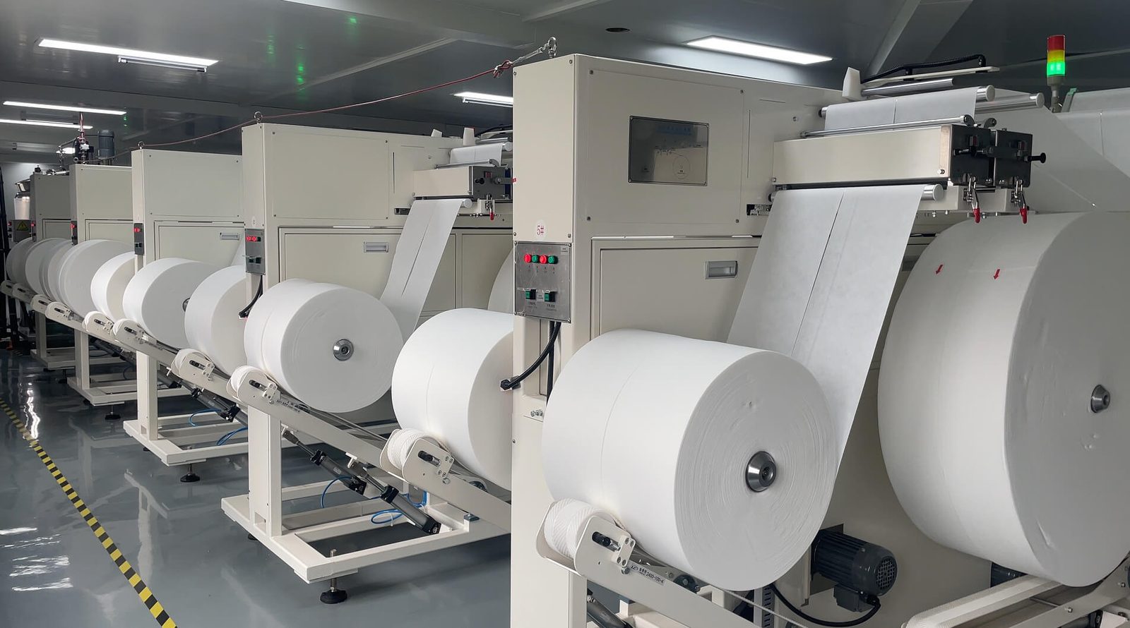 Nonwoven rolls feeding a wet-wipe converting line